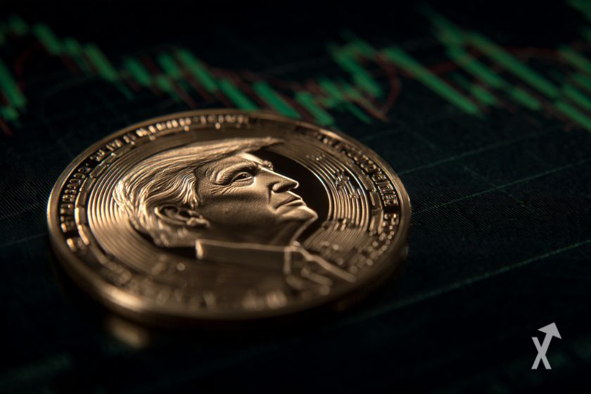 Une pièce avec le visage de Donald Trump posée sur un graphique technique