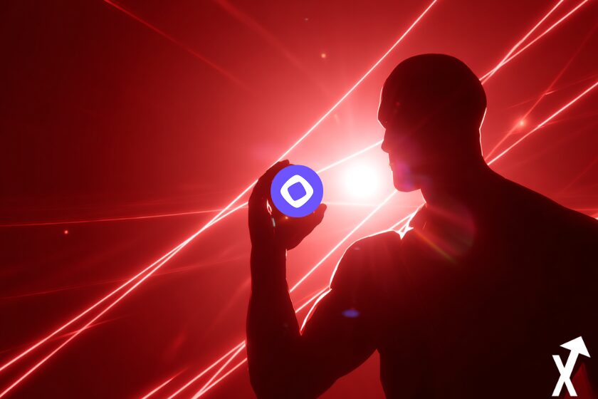 silhouette Arthur Hayes tenant jeton monad crypto sur fond rouge et lumiere centrale