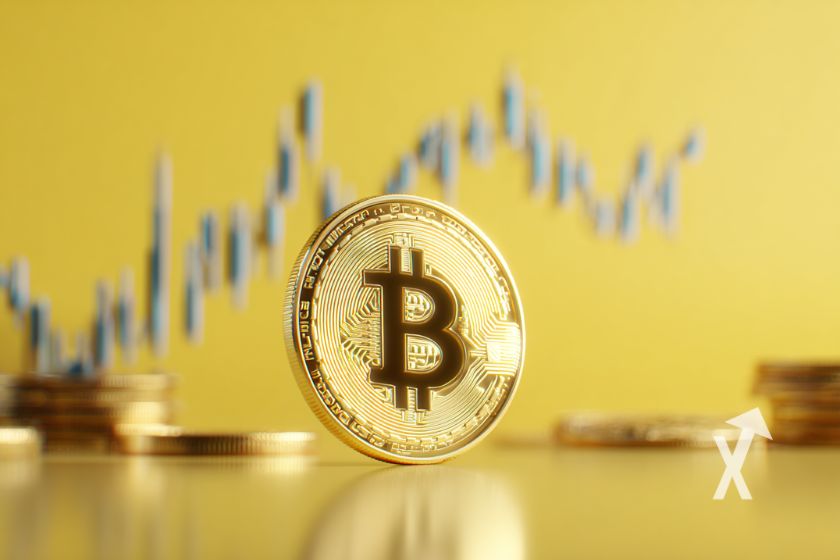 bitcoin coin en jaune sur un fond jaune avec une trendline grise en fond et des tokens empilés.