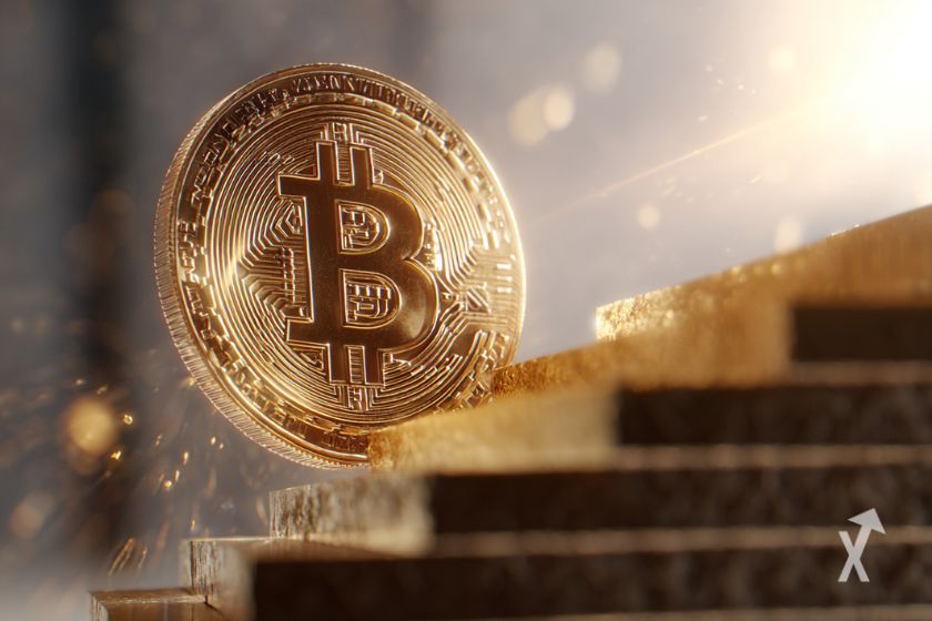 Une pièce de Bitcoin géante derrière des marches d'escaliers