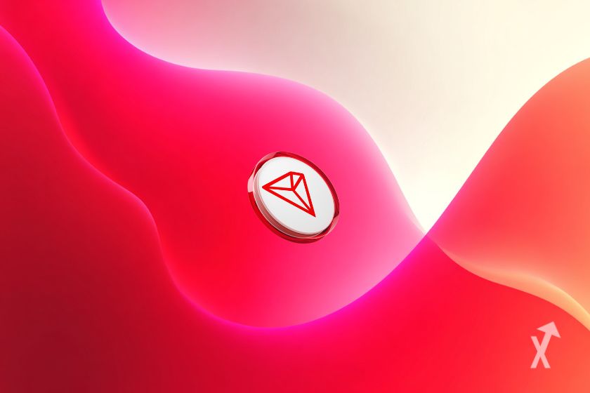 Un token blanc avec le logo TRX sur un fond rouge et blanc