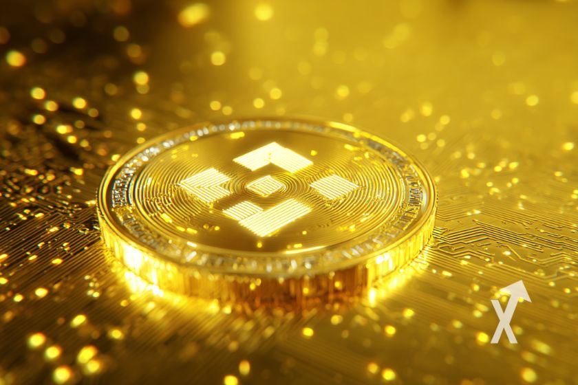 coin BNB en or sur un fond jaune or et des points lumineux dorés