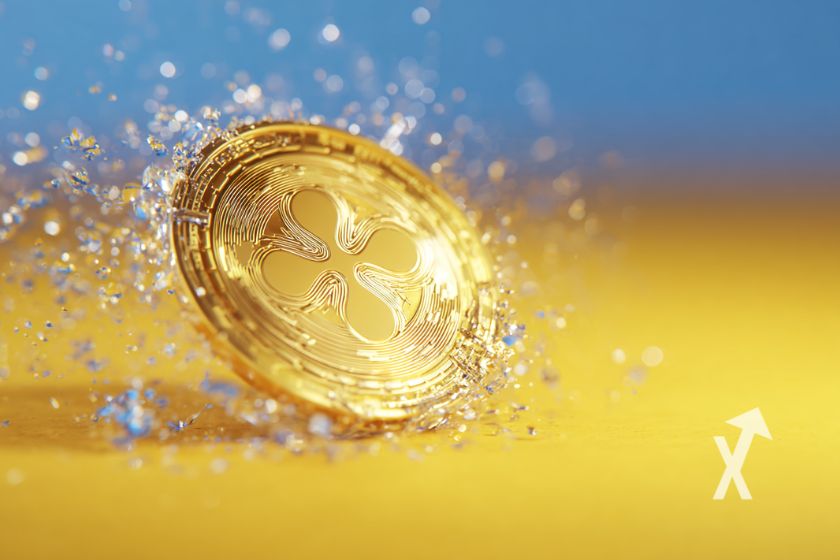 coin XRP jaune sur un fond bleu et jaune