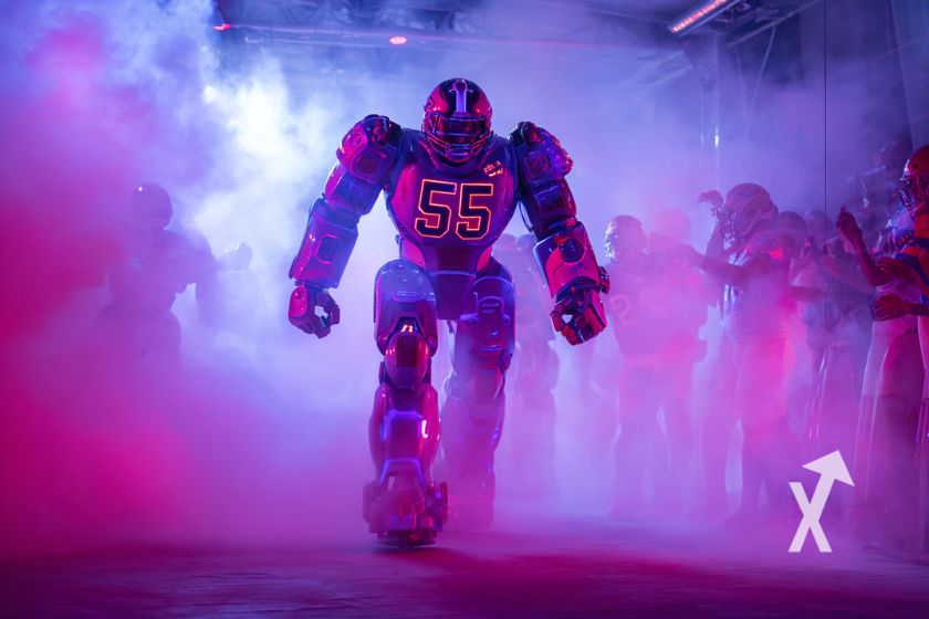 Robots avec un equipement NFL dans un fond de fumée rose