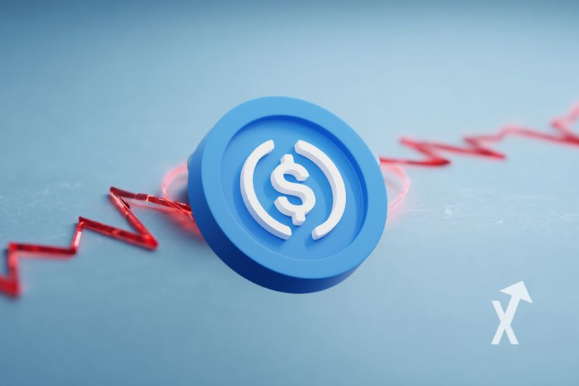 Coin usdc Circle sur un fond bleu avec trendline rouge