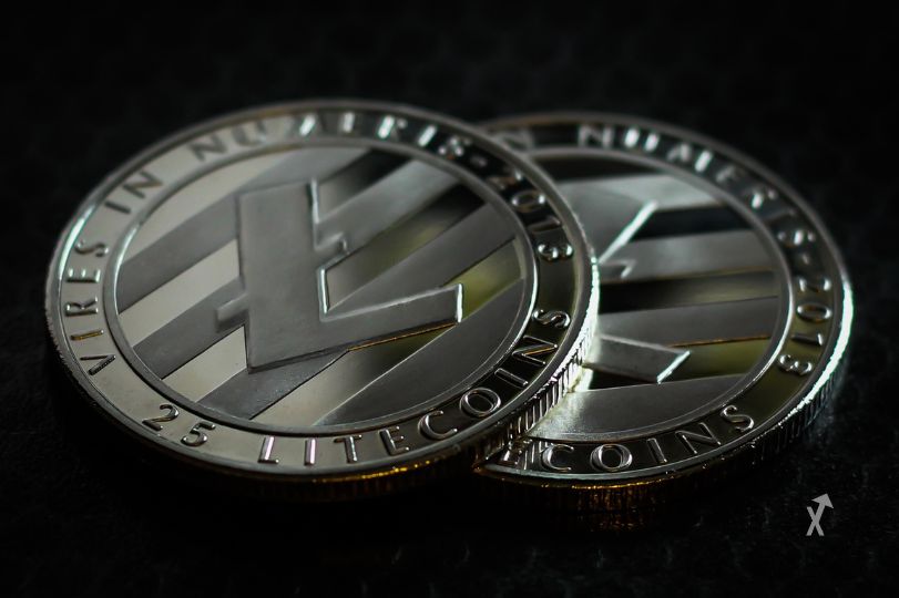 Cryptocurrency Litecoin logo on abstract background.