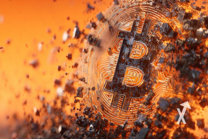 Bitcoin coin disintegrating into black particles.