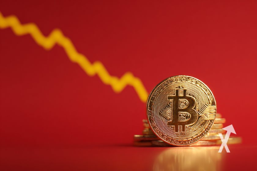 coin Bitcoin sur un fond rouge avec une trendline qui descend en jaune